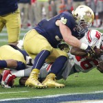 Ohio State quarterback J.T. Barrett (16) falls short of the goal line as Notre Dame linebacker Joe Schmidt (38) defends during the first half of the Fiesta Bowl NCAA College football game, Friday, Jan. 1, 2016, in Glendale, Ariz.  (AP Photo/Ross D. Franklin)