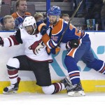 Arizona Coyotes' Anthony Duclair (10) is checked Edmonton Oilers' Darnell Nurse (25) during first period NHL action in Edmonton, on Saturday, Jan. 2, 2016. (Jason Franson/The Canadian Press via AP)