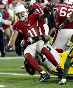 Arizona Cardinals wide receiver Larry Fitzgerald (11) scores the game winning touchdown in overtime as Green Bay Packers defensive end Mike Daniels (76) defends during the second half of an NFL divisional playoff football game, Saturday, Jan. 16, 2016, in Glendale, Ariz. The Cardinals won 26-20 in overtime. (AP Photo/Ross D. Franklin)