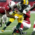 Green Bay Packers running back Eddie Lacy (27) is hit by Arizona Cardinals defensive end Calais Campbell (93) during the second half of an NFL divisional playoff football game, Saturday, Jan. 16, 2016, in Glendale, Ariz. (AP Photo/Rick Scuteri)