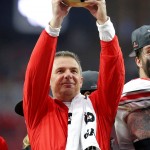 Ohio State head coach Urban Meyer raises the trophy after their 44-28 win over Notre Dame in the Fiesta Bowl NCAA College football game. Friday, Jan. 1, 2016, in Glendale, Ariz. (AP Photo/Rick Scuteri)