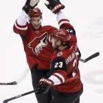 Arizona Coyotes' Oliver Ekman-Larsson (23), of Sweden, celebrates his game-winning goal against the Edmonton Oilers with Michael Stone, left, during overtime of an NHL hockey game Tuesday, Jan. 12, 2016, in Glendale, Ariz. The Coyotes defeated the Oilers 4-3. (AP Photo/Ross D. Franklin)