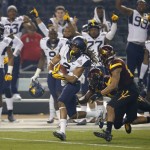 West Virginia wide receiver Ka'Raun White (2) pulls in a pass as Arizona State defensive back Kweishi Brown (10) gives chase during the first half of the Cactus Bowl NCAA college football game, Saturday, Jan. 2, 2016, in Phoenix. (AP Photo/Ross D. Franklin)