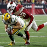 Green Bay Packers wide receiver Jeff Janis (83) is knocked out of bounds by Arizona Cardinals cornerback Justin Bethel (28) during the first half of an NFL divisional playoff football game, Saturday, Jan. 16, 2016, in Glendale, Ariz. (AP Photo/Ross D. Franklin)
