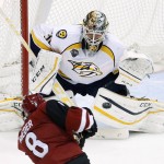 Nashville Predators' Carter Hutton, right, gets ready to make a save on a shot by Arizona Coyotes' Tobias Rieder (8) during the second period of an NHL hockey game Saturday, Jan. 9, 2016, in Glendale, Ariz. (AP Photo/Ross D. Franklin)