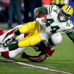 Green Bay Packers running back James Starks, top, is tackled by Arizona Cardinals outside linebacker Markus Golden (44) during the first half of an NFL divisional playoff football game, Saturday, Jan. 16, 2016, in Glendale, Ariz. (AP Photo/Rick Scuteri)