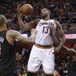 Cleveland Cavaliers' Tristan Thompson (13) grabs a rebound ahead of Phoenix Suns' Tyson Chandler (4) and Archie Goodwin (20) during the second half of an NBA basketball game Wednesday, Jan. 27, 2016, in Cleveland. The Cavaliers won 115-93. (AP Photo/Tony Dejak)