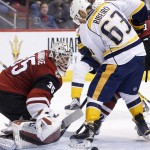 Arizona Coyotes' Louis Domingue (35) makes a save on a shot in front of Nashville Predators' Mike Ribeiro (63) during the third period of an NHL hockey game Saturday, Jan. 9, 2016, in Glendale, Ariz.  The Coyotes defeated the Predators 4-0. (AP Photo/Ross D. Franklin)
