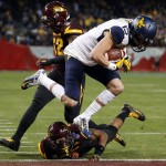 West Virginia's David Sills (15) scores a late touchdown as he beats Arizona State's Lloyd Carrington, bottom, and Antonio Longino, left, to the end zone during the second half of the Cactus Bowl NCAA college football game Saturday, Jan. 2, 2016, in Phoenix. West Virginia won 43-42. (AP Photo/Ross D. Franklin)