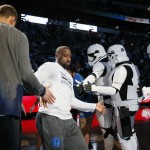 Dallas Mavericks guard Raymond Felton, center, is greeted by teammates and persons dressed in Star Wars themed costumes during team introductions before an NBA basketball game against the Phoenix Suns on Sunday, Jan. 31, 2016, in Dallas. The Mavericks celebrated Star Wars night during the game. (AP Photo/Tony Gutierrez)
