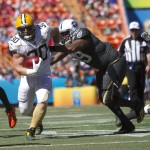 Green Bay Packers fullback John Kuhn (30)  of Team Rice tries to get away from Tennessee Titans defensive tackle Jurrell Casey (99) of Team Irvin during the first quarter of the NFL Pro Bowl football game, Sunday, Jan. 31, 2016, in Honolulu. (AP Photo/Marco Garcia)