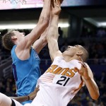 Charlotte Hornets' Cody Zeller, left, pulls down a rebound on a missed shot by Phoenix Suns' Alex Len (21) during the second half of an NBA basketball game Wednesday, Jan. 6, 2016, in Phoenix.  The Suns defeated the Hornets 111-102. (AP Photo/Ross D. Franklin)
