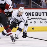 Arizona Coyotes' Kevin Connauton, left, sends the puck past Los Angeles Kings' Dustin Brown (23) during the first period of an NHL hockey game Saturday, Jan. 23, 2016, in Glendale, Ariz. (AP Photo/Ross D. Franklin)