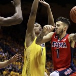 Arizona's Gabe York, right, looks to pass away from California's Roger Moute a Bidias, left, and Ivan Rabb in the first half of an NCAA college basketball game Saturday, Jan. 23, 2016, in Berkeley, Calif. (AP Photo/Ben Margot)