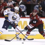 Buffalo Sabres left wing Matt Moulson (26) and Arizona Coyotes left wing Jordan Martinook battle for the puck in the first period during an NHL hockey game Monday, Jan. 18, 2016, in Glendale, Ariz. (AP Photo/Rick Scuteri)