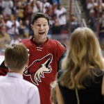 Arizona Coyotes' Shane Doan smiles as he greets his wife and kids as he is recognized for becoming the franchise leader for goals, with his 380th, during ceremonies prior to an NHL hockey game against the San Jose Sharks, Thursday, Jan. 21, 2016, in Glendale, Ariz. (AP Photo/Ross D. Franklin)