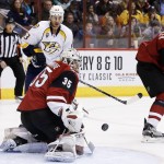 Arizona Coyotes' Louis Domingue (35) makes a save on a shot by Nashville Predators' Mike Ribeiro (63) as Coyotes' Zbynek Michalek (4), of the Czech Republic, watches the puck for a rebound during the first period of an NHL hockey game Saturday, Jan. 9, 2016, in Glendale, Ariz. (AP Photo/Ross D. Franklin)