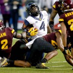 West Virginia running back Wendell Smallwood (4) is tackled by Arizona State linebacker Christian Sam (2) during the first half of the Cactus Bowl NCAA College football game, Saturday, Jan. 2, 2016, in Phoenix. (AP Photo/Matt York)