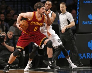 Brooklyn Nets guard Markel Brown (22) defends Cleveland Cavaliers forward Kevin Love (0) in the second half of an NBA basketball game, Wednesday, Jan. 20, 2016, in New York. Love and LeBron James led the Cavaliers with 17 points each in the Cavs 91-78 victory over the Nets. (AP Photo/Kathy Willens)
