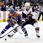Arizona Coyotes' Connor Murphy (5) battles for the puck with Edmonton Oilers' Benoit Pouliot (67) during second period NHL action in Edmonton, Alberta, on Saturday, Jan. 2, 2016. (Jason Franson/The Canadian Press via AP)