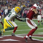 Arizona Cardinals wide receiver Michael Floyd (15) catches a tipped pass in the end zone for a touchdown as Green Bay Packers cornerback Casey Hayward (29) defends during the second half of an NFL divisional playoff football game, Saturday, Jan. 16, 2016, in Glendale, Ariz. (AP Photo/Rick Scuteri)