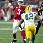 Arizona Cardinals quarterback Carson Palmer (3) throws as Green Bay Packers strong safety Morgan Burnett (42) pursues during the second half of an NFL divisional playoff football game, Saturday, Jan. 16, 2016, in Glendale, Ariz. (AP Photo/Ross D. Franklin)