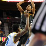 Arizona State's Tra Holder, top, shoots over UCLA's Aaron Holiday in the first half of an NCAA college basketball game in Los Angeles, Saturday, Jan. 9, 2016. (AP Photo/Michael Owen Baker)