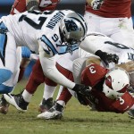 Arizona Cardinals' Carson Palmer fumbles as he is hit by Carolina Panthers' Kawann Short and Mario Addison (97) during the first half the NFL football NFC Championship game Sunday, Jan. 24, 2016, in Charlotte, N.C. (AP Photo/Bob Leverone)