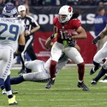 Arizona Cardinals wide receiver Larry Fitzgerald (11) makes a catch as Seattle Seahawks free safety Earl Thomas (29) and linebacker Bruce Irvin (51) pursue during the first half of an NFL football game, Sunday, Jan. 3, 2016, in Glendale, Ariz. (AP Photo/Rick Scuteri)