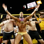 Olympic swimmer Michael Phelps, center, performs behind the "Curtain of Distraction" during an Oregon State free throw against Arizona State in the second half of an NCAA college basketball game, Thursday, Jan. 28, 2016, in Tempe, Ariz. (AP Photo/Matt York)
