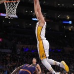 Los Angeles Lakers forward Larry Nance Jr., right, dunks as Phoenix Suns forward P.J. Tucker, left, ducks away during the first half of an NBA basketball game, Sunday, Jan. 3, 2016, in Los Angeles. (AP Photo/Mark J. Terrill)