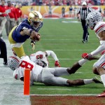 Notre Dame quarterback DeShone Kizer (14) lunges for the goal line but is stopped short by Ohio State cornerback Gareon Conley (8) during the first half of the Fiesta Bowl NCAA College football game, Friday, Jan. 1, 2016, in Glendale, Ariz.  (AP Photo/Rick Scuteri)