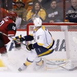 Arizona Coyotes' Anthony Duclair (10) scores a goal against Nashville Predators' Carter Hutton, right, as Predators' Shea Weber (6) watches during the third period of an NHL hockey game Saturday, Jan. 9, 2016, in Glendale, Ariz. The Coyotes defeated the Predators 4-0. (AP Photo/Ross D. Franklin)
