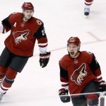 Arizona Coyotes' Max Domi, right, shouts as he celebrates his hat trick against the Edmonton Oilers as teammate Oliver Ekman-Larsson (23), of Sweden, skates in to join the celebration during the third period of an NHL hockey game Tuesday, Jan. 12, 2016, in Glendale, Ariz.  The Coyotes defeated the Oilers 4-3. (AP Photo/Ross D. Franklin)