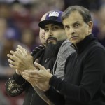San Francisco Giants reliever Sergio Romo, left, joins Sacramento Kings majority owner Vivek Ranadive, right, in applauding the Kings during the second half of their 142-119 win over the Phoenix Suns in an NBA basketball game Saturday, Jan. 2, 2016, in Sacramento, Calif.  (AP Photo/Rich Pedroncelli)