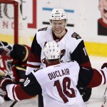 Arizona Coyotes' Martin Hanzal, top, from Czech Republic, celebrates his goal against the Calgary Flames with teammate Anothony Duclair during the third period of an NHL hockey game Thursday, Jan. 7, 2015, in Calgary, Alberta. (Larry MacDougal/The Canadian Press via AP)