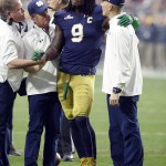 Notre Dame linebacker Jaylon Smith (9) is attended to after being injured in the first half of the Fiesta Bowl NCAA College football game against Ohio State, Friday, Jan. 1, 2016, in Glendale, Ariz.  (AP Photo/Rick Scuteri)