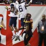 West Virginia's Shelton Gibson (1) celebrates his touchdown with Daikiel Shorts (6) as Arizona State's Lloyd Carrington (8) looks away during the first half of the Cactus Bowl NCAA college football game Saturday, Jan. 2, 2016, in Phoenix. (AP Photo/Ross D. Franklin)