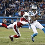 Carolina Panthers' Ted Ginn gets past Arizona Cardinals' Justin Bethel for a touchdown run during the first half the NFL football NFC Championship game Sunday, Jan. 24, 2016, in Charlotte, N.C. (AP Photo/Bob Leverone)