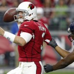 Arizona Cardinals quarterback Carson Palmer (3) is pressured by Seattle Seahawks defensive end Cliff Avril during the first half of an NFL football game, Sunday, Jan. 3, 2016, in Glendale, Ariz. (AP Photo/Ross D. Franklin)
