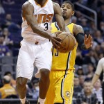 Phoenix Suns' Brandon Knight (3) gets fouled as he drives past Indiana Pacers' Paul George, right, during the second half of an NBA basketball game Tuesday, Jan. 19, 2016, in Phoenix.  The Pacers defeated the Suns 97-94. (AP Photo/Ross D. Franklin)
