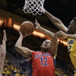 Arizona's Ryan Anderson, center, tries to shoot between California's Sam Singer, left, and Roger Moute a Bidias in the first half of an NCAA college basketball game Saturday, Jan. 23, 2016, in Berkeley, Calif. (AP Photo/Ben Margot)