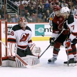 New Jersey Devils goalie Cory Schneider (35) has the puck deflect off his pads in front of Arizona Coyotes' Shane Doan, center, and the Devils' Jon Merrill during the third period of an NHL hockey game, Saturday, Jan. 16, 2016, in Glendale, Ariz. The Devils defeated the Coyotes 2-0. (AP Photo/Ralph Freso)