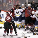Arizona Coyotes right wing Shane Doan (19) gets held back in a fight after an NHL hockey game the Buffalo Sabres, Monday, Jan. 18, 2016, in Glendale, Ariz. (AP Photo/Rick Scuteri)