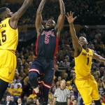 Arizona's Kadeem Allen, center, drives to the basket between the defense of Arizona State's Obinna Oleka, left, and Maurice O'Field, right, during the second half of an NCAA college basketball game, Sunday, Jan. 3, 2016, in Tempe, Ariz. (AP Photo/Ralph Freso)