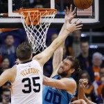 Charlotte Hornets' Spencer Hawes (00) battles Phoenix Suns' Mirza Teletovic (35) for a rebound during the first half of an NBA basketball game Wednesday, Jan. 6, 2016, in Phoenix. (AP Photo/Ross D. Franklin)
