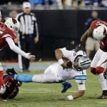 Carolina Panthers' Cam Newton is tackled after a run during the first half the NFL football NFC Championship game against the Arizona Cardinals, Sunday, Jan. 24, 2016, in Charlotte, N.C. (AP Photo/David J. Phillip)