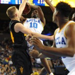 UCLA's Isaac Hamilton shoots in traffic against Arizona State's Kodi Justice in the second half of an NCAA college basketball game in Los Angeles, Saturday, Jan. 9, 2016. UCLA won 81-74. (AP Photo/Michael Owen Baker)