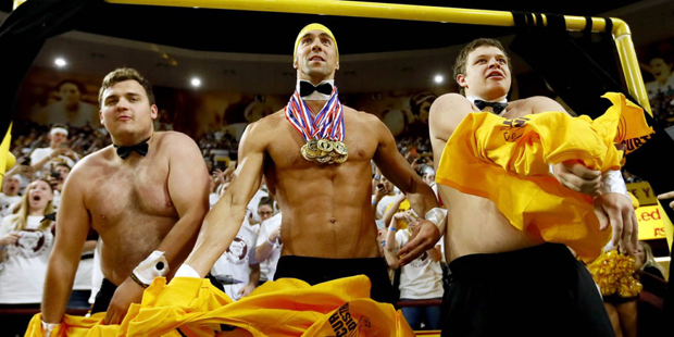 Olympic swimmer Michael Phelps, center, performs behind the "Curtain of Distraction" during an Oreg...