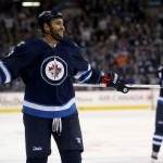 Winnipeg Jets' Dustin Byfuglien (33) laughs after scoring from just inside center ice against the Arizona Coyotes during the second period of an NHL hockey game Tuesday, Jan 26, 2016, in Winnipeg, Manitoba. (Trevor Hagan/The Canadian Press via AP)